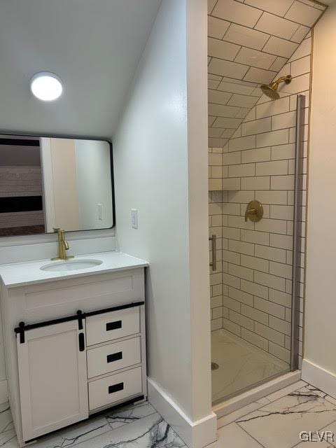 bathroom featuring marble finish floor, a shower stall, baseboards, and vanity