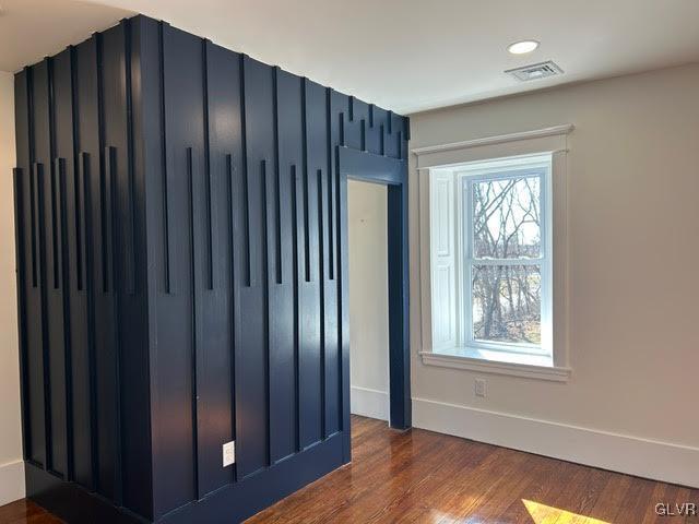 interior space featuring recessed lighting, dark wood-style flooring, visible vents, and baseboards