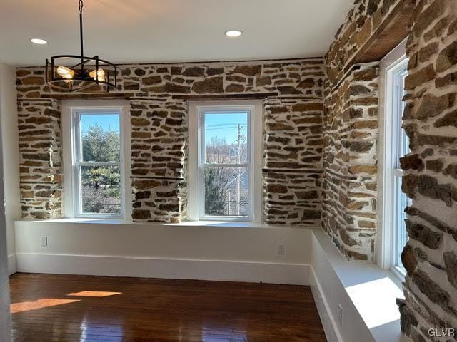 unfurnished dining area with recessed lighting, dark wood finished floors, a wealth of natural light, and baseboards