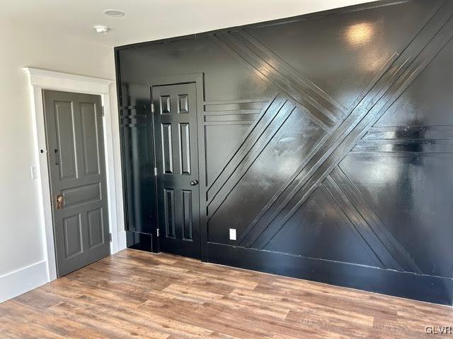 empty room with baseboards and light wood-style floors