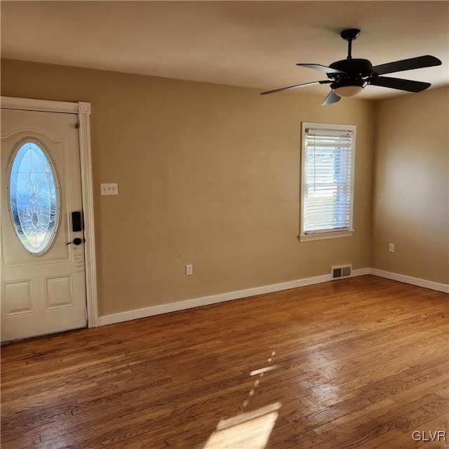 entrance foyer with ceiling fan and wood-type flooring