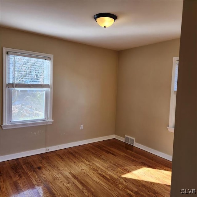 spare room with wood-type flooring