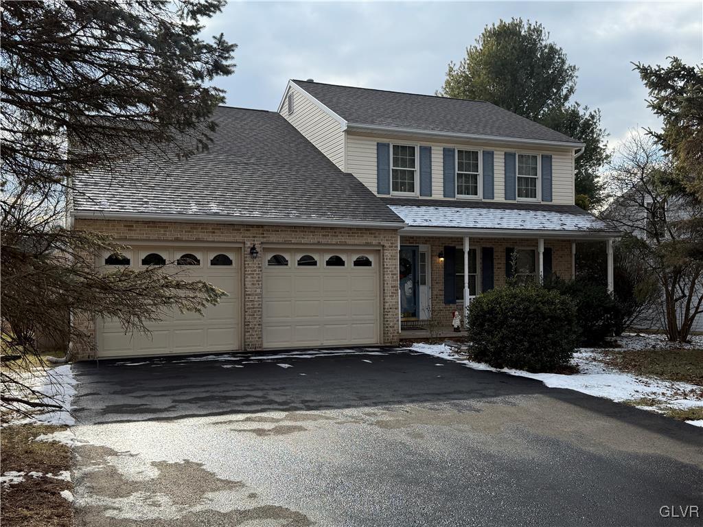 view of front property with covered porch and a garage