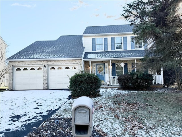 view of front property with covered porch and a garage