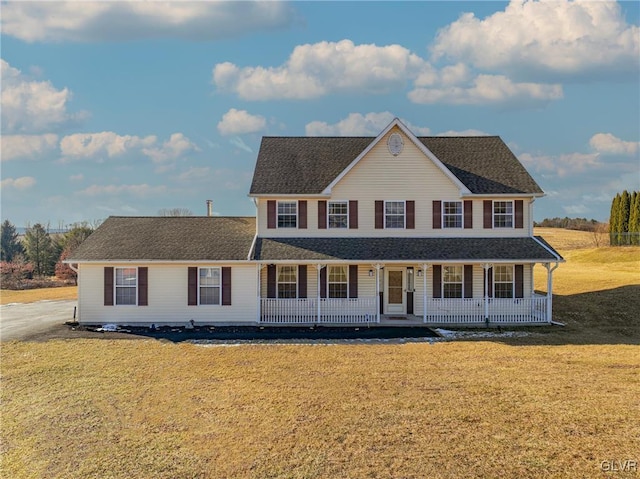 view of front facade featuring covered porch and a front yard