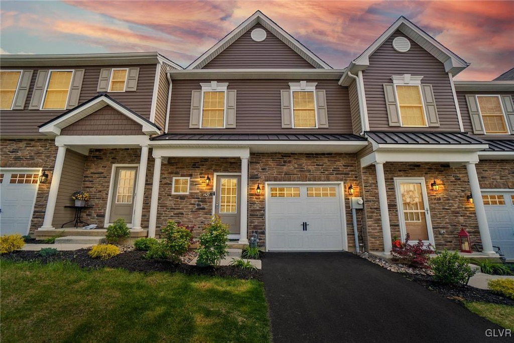 view of front of home featuring a garage and a lawn