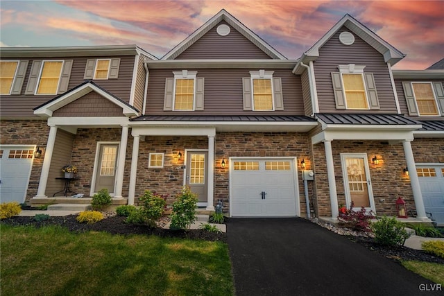 view of front of home featuring a garage and a lawn