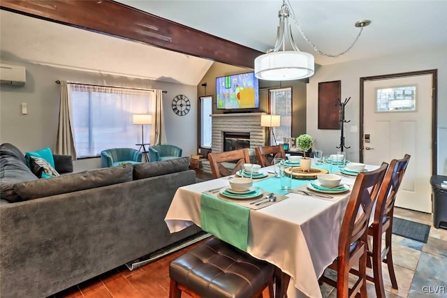 dining room with a wall mounted AC, a brick fireplace, and lofted ceiling with beams