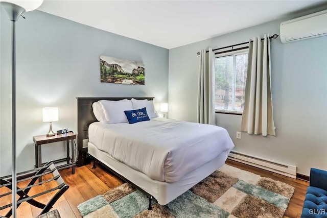 bedroom with a wall mounted AC, hardwood / wood-style floors, and a baseboard heating unit