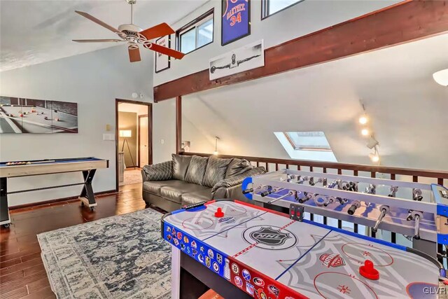 game room featuring ceiling fan, a skylight, and high vaulted ceiling