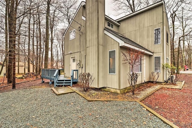 rear view of property featuring a deck