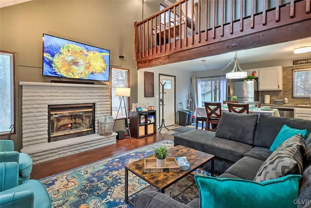 living room featuring a high ceiling and hardwood / wood-style floors