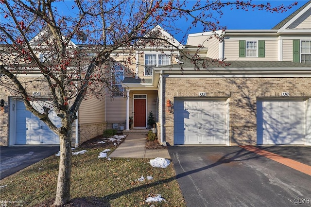 townhome / multi-family property featuring a garage