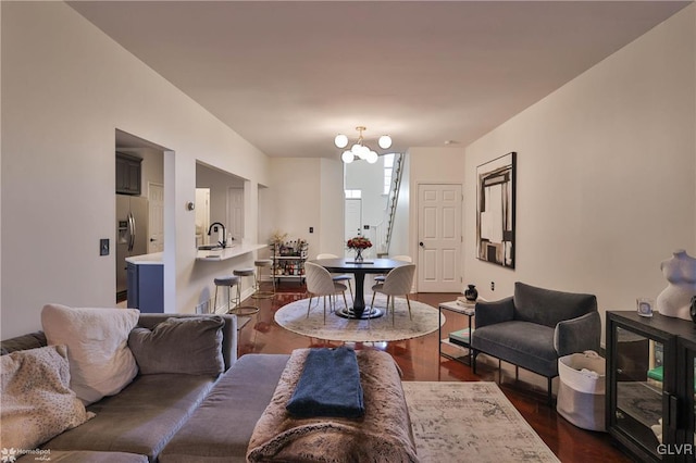 living room featuring sink, dark hardwood / wood-style flooring, and a notable chandelier