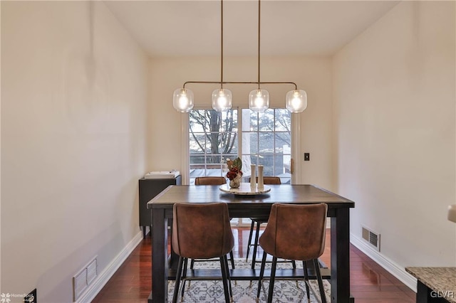 dining space featuring dark wood-type flooring