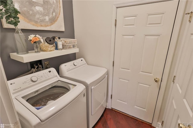 laundry room with independent washer and dryer and dark hardwood / wood-style flooring