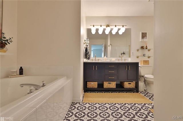 bathroom with vanity, tile patterned flooring, toilet, and a relaxing tiled tub