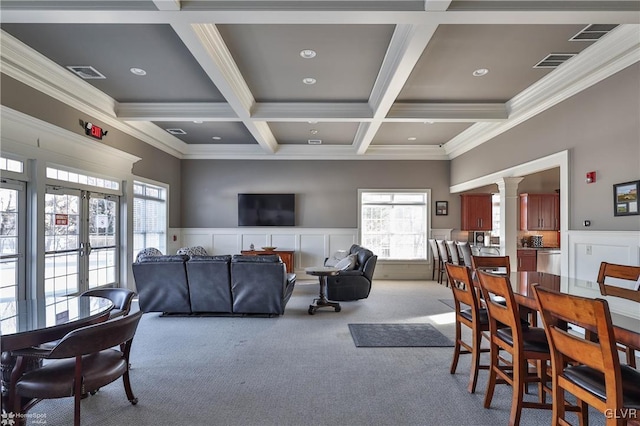 dining area featuring crown molding, coffered ceiling, light carpet, and beamed ceiling