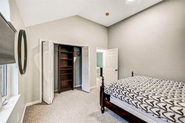 carpeted bedroom featuring vaulted ceiling and a closet