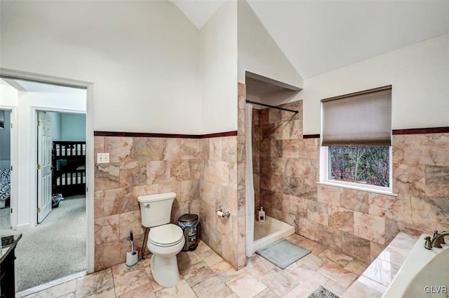 bathroom featuring tile walls, vaulted ceiling, plus walk in shower, and toilet