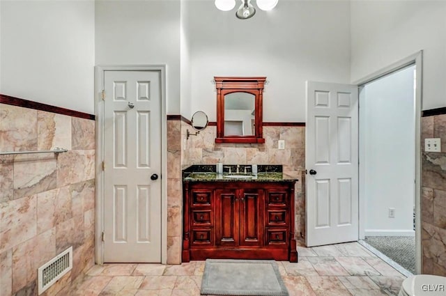 bathroom featuring tile walls and vanity