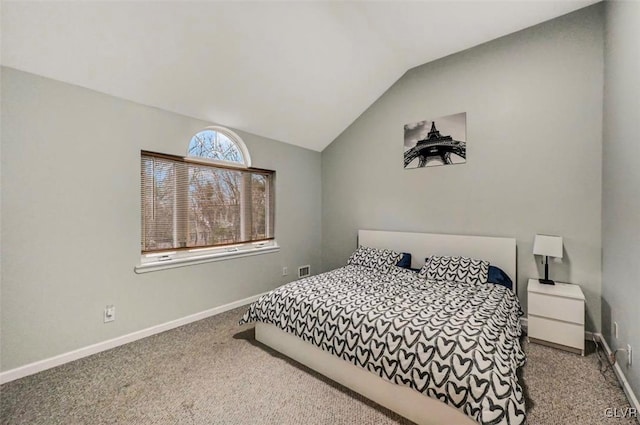 bedroom featuring lofted ceiling and carpet floors