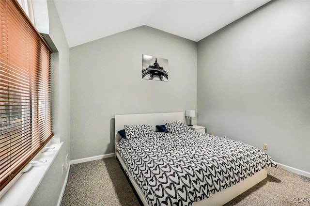 bedroom with vaulted ceiling and dark carpet