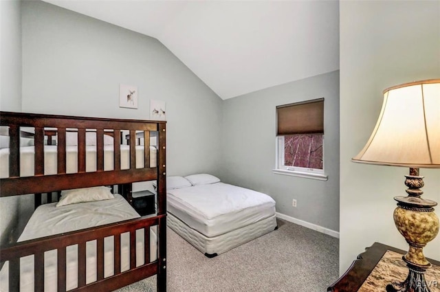 carpeted bedroom with vaulted ceiling