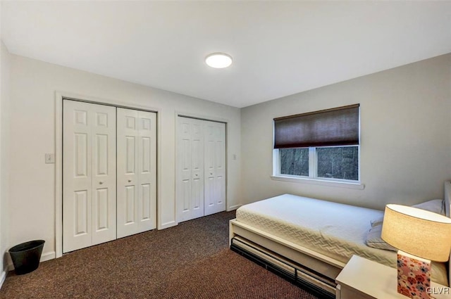 carpeted bedroom featuring two closets