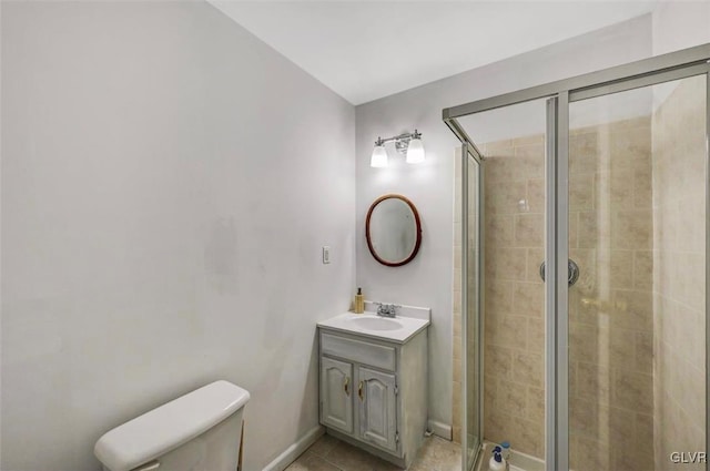 bathroom with toilet, vanity, tile patterned flooring, and walk in shower