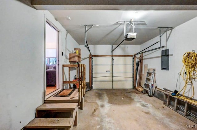 garage with electric panel and a garage door opener