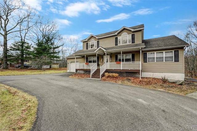 view of front of home with covered porch and a garage