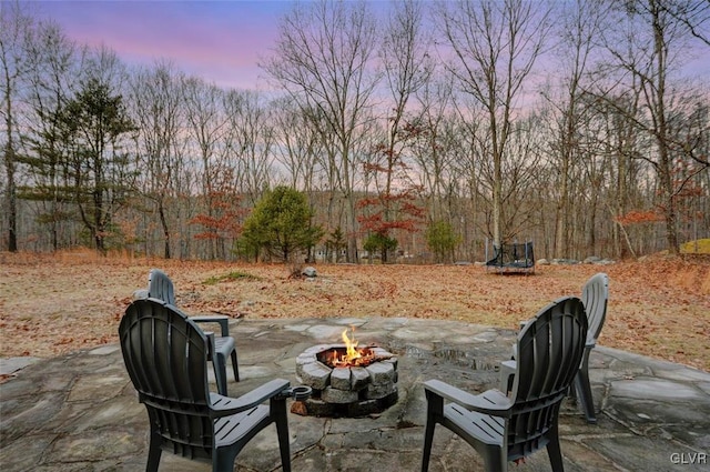 patio terrace at dusk featuring a fire pit