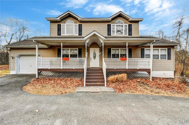 view of front facade featuring covered porch and a garage