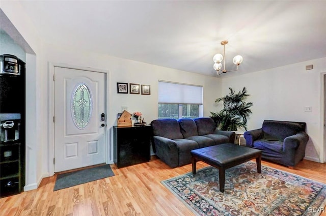 living room featuring hardwood / wood-style flooring and an inviting chandelier