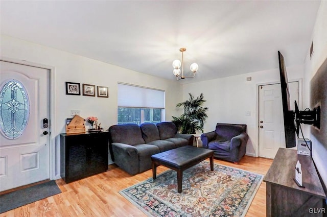 living room featuring hardwood / wood-style flooring and an inviting chandelier