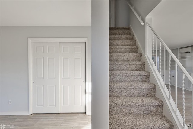 staircase featuring a wall unit AC