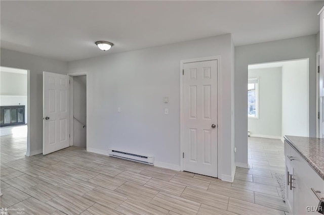 empty room featuring a baseboard radiator