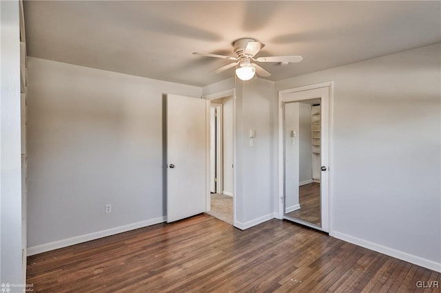 unfurnished bedroom with a closet, ceiling fan, and dark hardwood / wood-style flooring