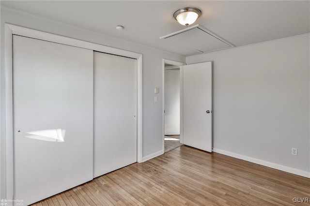 unfurnished bedroom with a closet and light hardwood / wood-style flooring