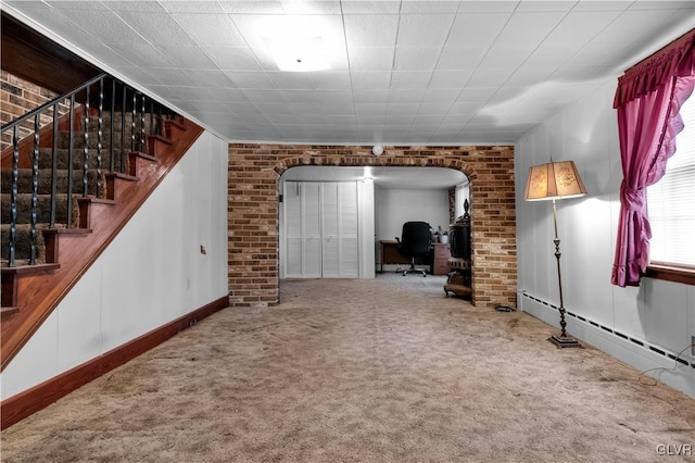 unfurnished living room featuring a baseboard heating unit and carpet flooring