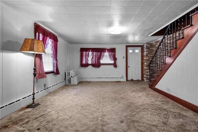 entryway with carpet floors, plenty of natural light, and a baseboard heating unit