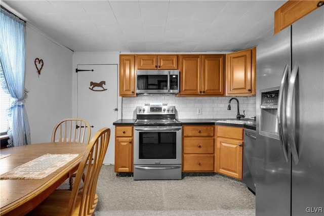 kitchen featuring sink, stainless steel appliances, and tasteful backsplash