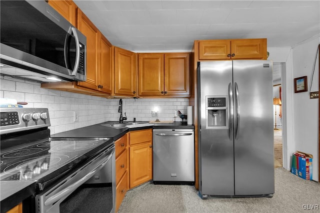 kitchen with stainless steel appliances, tasteful backsplash, and sink