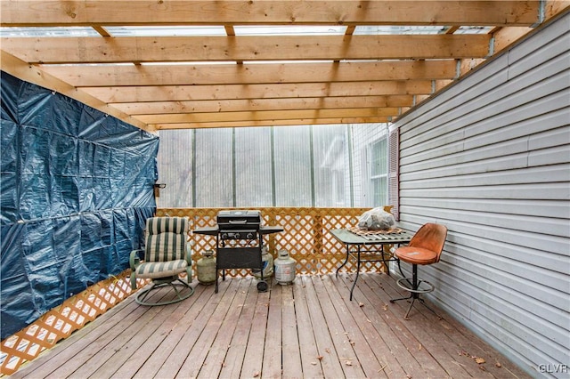 deck with grilling area and a pergola