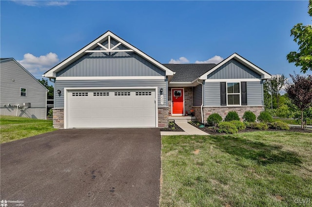 craftsman house with a front lawn and a garage