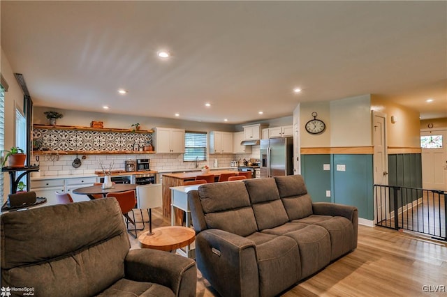 living room featuring sink and light wood-type flooring