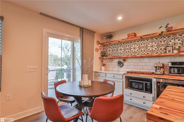 kitchen featuring light hardwood / wood-style flooring, wood counters, backsplash, and wine cooler