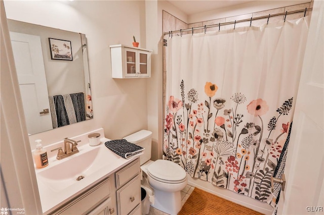 bathroom with walk in shower, tile patterned floors, vanity, and toilet