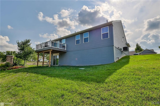 rear view of property with a yard and a deck